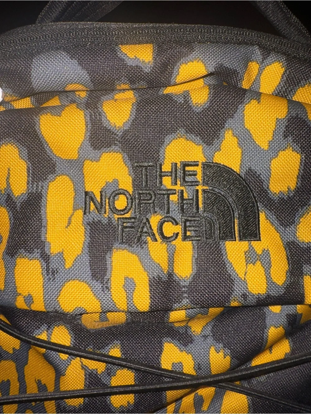 The North Face Black and Yellow Leopard Print Mini Backpack